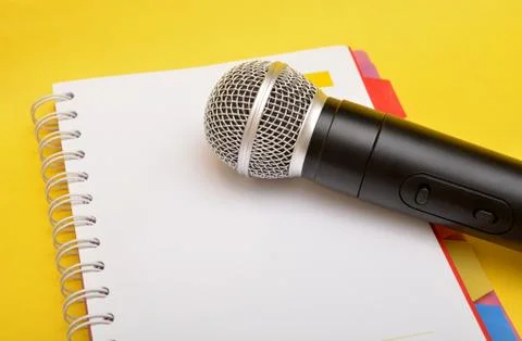 Wireless microphone with note book - movitional speaker Stock Photos