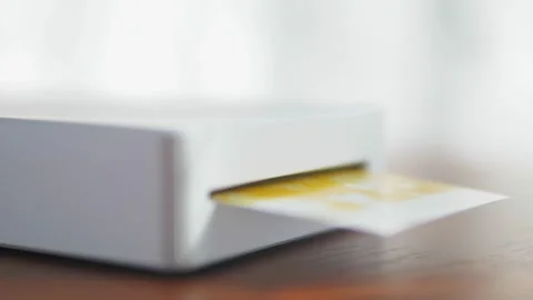 Wireless mini printer for smartphones. Process of printing photos with a Stock Footage 218395829