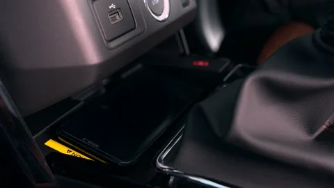 Wireless mobile charging in car Stock Footage 267564624