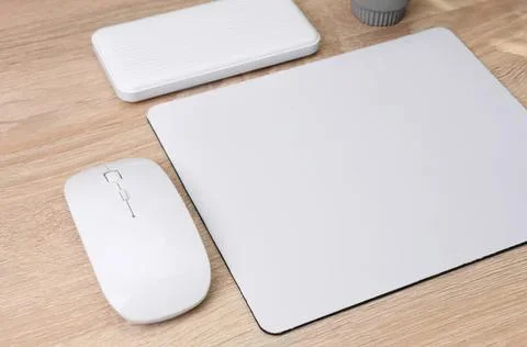 Wireless mouse and mouse pad on wooden desk Stock Photos
