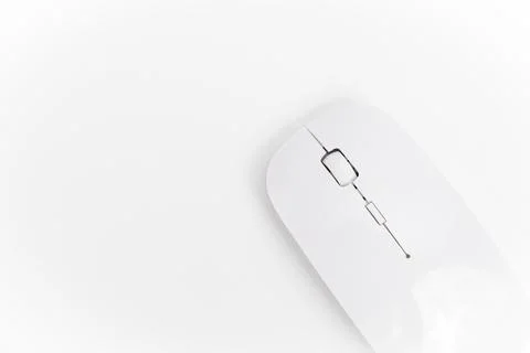 Wireless mouse on a white surface used for computer tasks Stock Photos