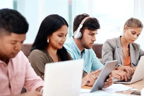 Wireless is the only way to work. a group of young business colleagues sitting Stock Photos