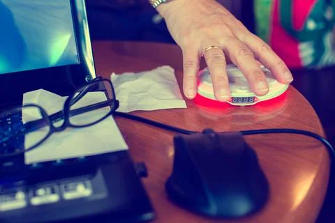 Wireless queue caller machine in hand of customer. Stock Photos