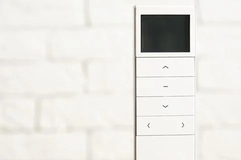Wireless remote controller with display and button for smart home Stock Photos