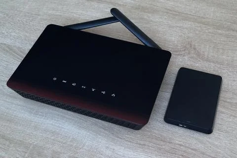 Wireless router and external storage device on wooden office desk, cloud ne.. 스톡 사진