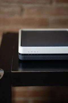 Wireless router modem with active blue indicator lights Stock Photos
