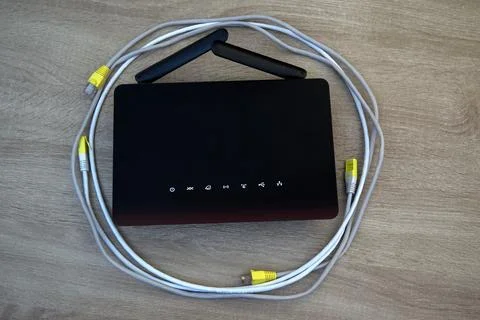 Wireless router surrounded by coiled network cables Stock Photos