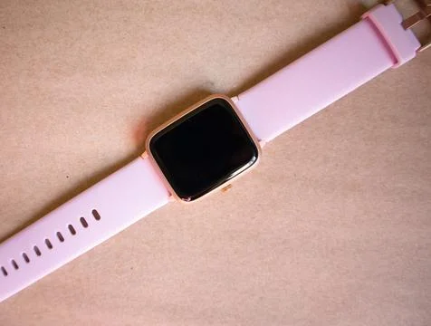 Wireless Smart Watch with Pink Strap Isolated on Brown kraft Paper Background Stock Photos