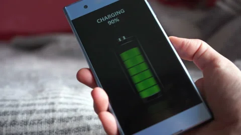 Wireless smartphone charging concept, full green battery icon on a phone screen Stock Footage 131734517