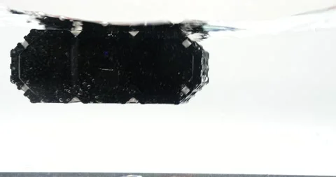 Wireless speaker falling into the water isolated on white splashing liquid Stock Footage 219520874