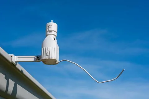 Wireless sprinkler rain sensor used to conserve water. Device is installed on a Stock Photos