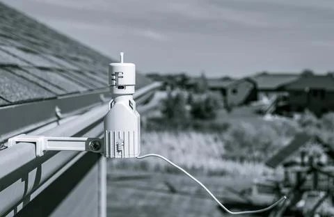 Wireless sprinkler rain sensor used to conserve water. Device is installed on a Stock Photos