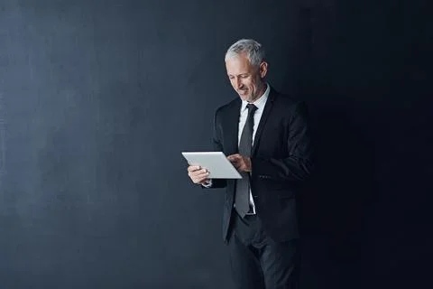 Wireless technology keeps him proactive in running his business. Studio shot of Stock Photos