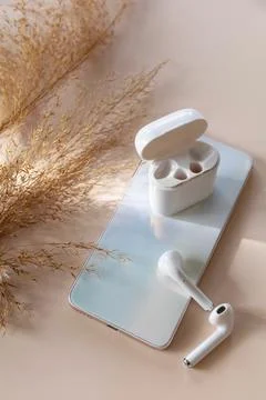 Wireless technology, modern tech. Minimal shot smartphone and of a pair of wh Stock Photos
