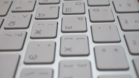 Wireless thin keyboard close -up. The keys are white. Camer slides approaching Stock Footage 232986892