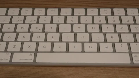 Wireless White Computer Keyboard on Wooden Desk, Static Close-Up Stock Footage 345552163