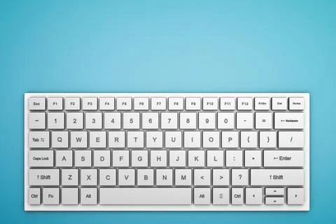 Wireless white keyboard on a blue table. View from above. Copy space. Stock Photos