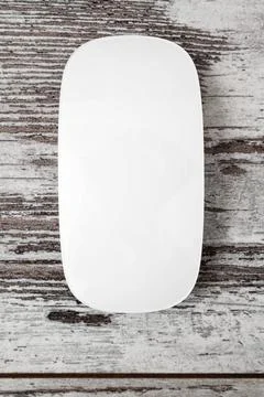 Wireless White Modern Computer Mouse on Light Wooden Background Wireless w... Stock Photos