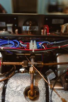 Wires and components connected on a machine in a workshop during daytime sh.. Stock Photos