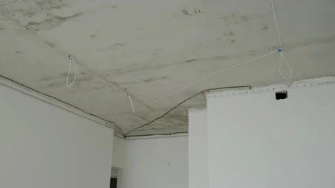 Wires attached to ceiling in room of unfinished apartments Stock Footage 167961408