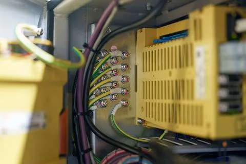 Wires connect to an electrical panel in a control box during maintenance at.. 스톡 사진