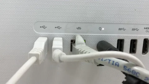 Wires plugged in charging in the computer Stock Footage 132970311