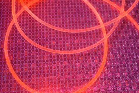 Wires of soft red, cherry, pink glow are on graphic pink, silver reflection. Foto stock