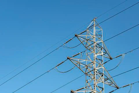 Wiring and connection elements in an electricity turret on blue sky backgroun Stock Photos