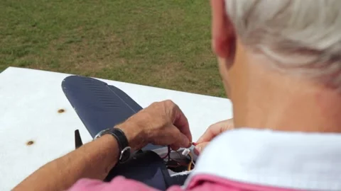 Wiring Up A Model Plane In An Over The Shoulder Shot With Moving Wings Sunny Day Stock Footage 130676663