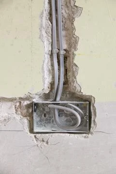 Wiring a plug socket into a house wall UK Stock Photos