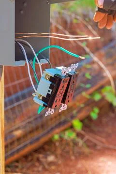Wiring process of electrical components in outdoor environment during works day Stock Photos