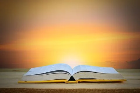 Wisdom, education and knowledge concept, book on table with twilight backgr.. Fotos de archivo
