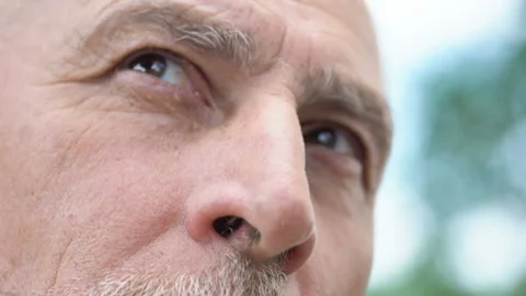 Wisdom in eyes of aged man looking up closeup, senior person thinking about past Video stock 94402297