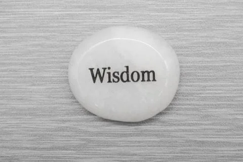 Wisdom mood stone on a gray background Stock Photos
