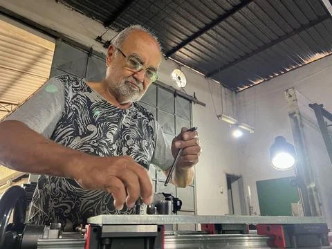 Wise experienced blacksmith man working Stock Photos