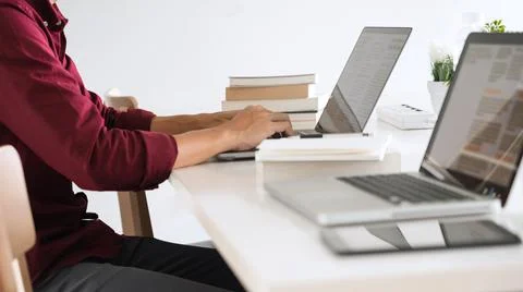 A wise officer going on internet for preparing the agenda in upcoming meeting Stock Photos