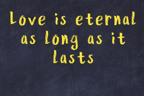 Wise quotation and a chalk drawing of a bulb on black chalkboard Stock Photos