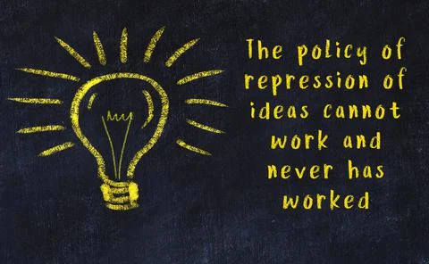 Wise quotation and a chalk drawing of a bulb on black chalkboard 库存照片