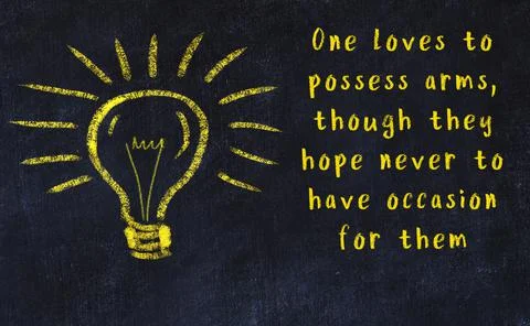 Wise quotation and a chalk drawing of a bulb on black chalkboard Фото