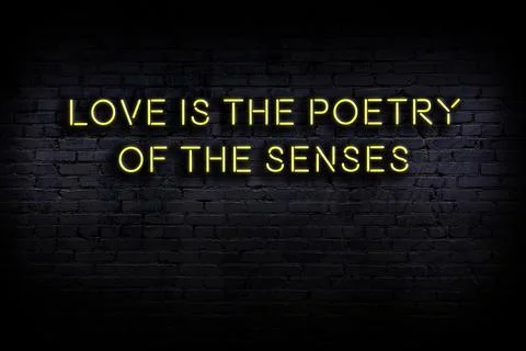 Wise quotation as light neon sign on brick wall Stock Photos