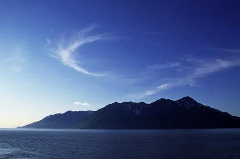 Wisp of clouds over mountains Stock Photos