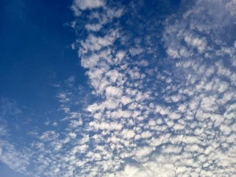 Wisps of clouds in a clear blue sky Stock Photos