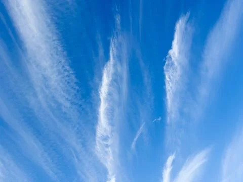 Wispy Cirrus Clouds Against a Bright Blue Sky Stock Photos