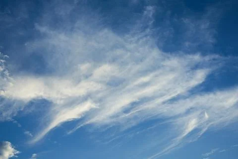 Wispy Cirrus Clouds in Blue Sky Фото
