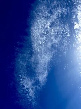 Wispy Cirrus Clouds in a Deep Blue Sky Stock Photos