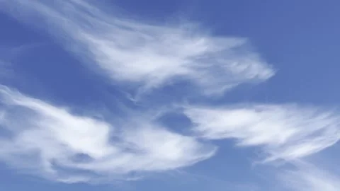 Wispy Cirrus Clouds Drifting Across a Deep Blue Sky Stock Footage 339378280