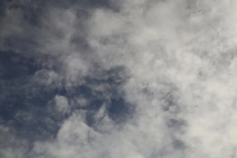 Wispy Clouds Against a Deep Blue Sky Creating Dreamy Atmosphere Stock Photos