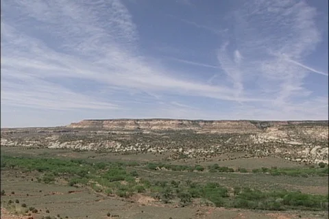 Wispy Clouds in Blue Sky above Steep Cliffs in Utah Stock Footage 121485056