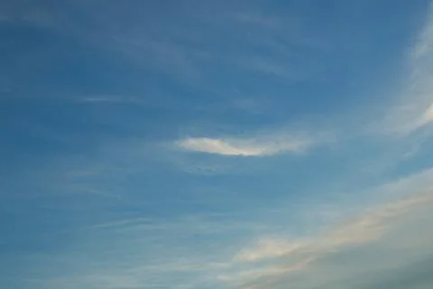 Wispy Clouds in a Clear Blue Sky Stock Photos