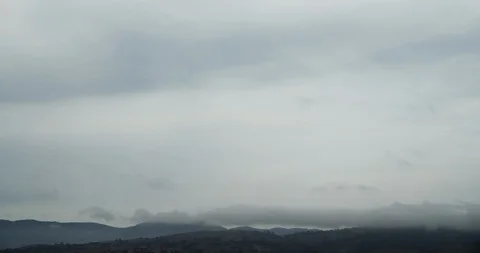 Wispy Grey Clouds Over Mountains 4K 스톡 동영상 113918949